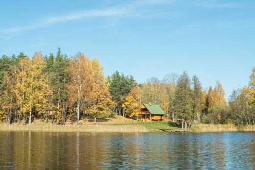 a cabin on the shore of a lake at "Čiekuri" in Aglona