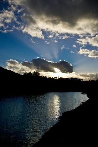 a sunset over a body of water with a cloudy sky at Quinta da Lapa in Manique do Intendente