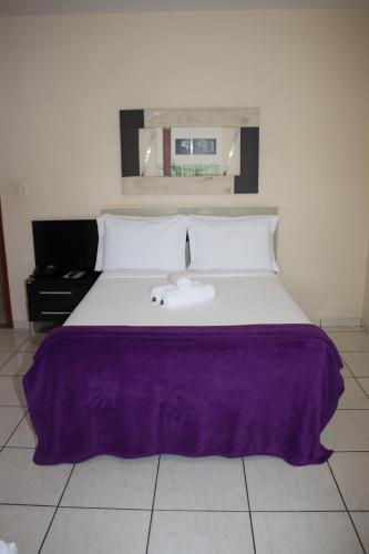 Katil atau katil-katil dalam bilik di Gabvini Hotel