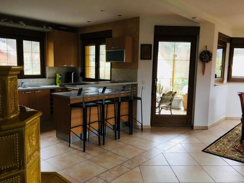 a kitchen with a island in the middle of a room at Buhl de Bonheur in Guebwiller