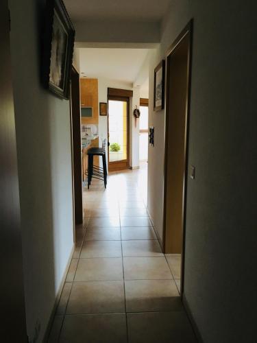 a hallway with a door and a tile floor at Buhl de Bonheur in Guebwiller