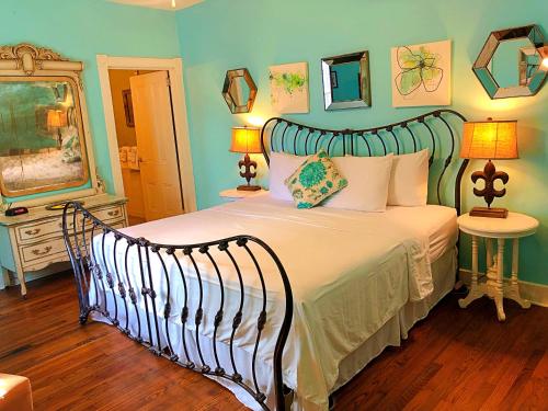 a bedroom with a large bed in a room at Creole Gardens Guesthouse and Inn in New Orleans