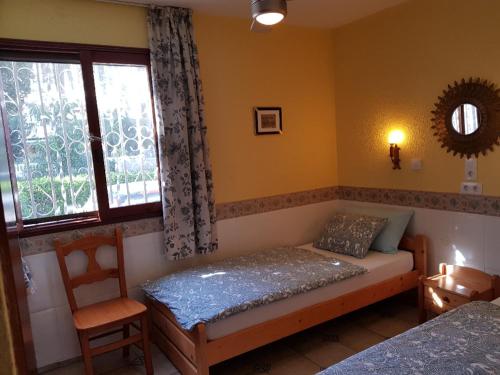 ein Schlafzimmer mit einem Bett und einem Fenster in der Unterkunft Bungalows Bahamas beside the park and 300m to the beach in Puerto Rico de Gran Canaria