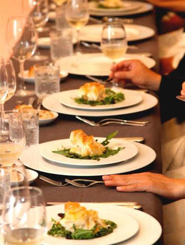 a long table with plates of food and glasses of wine at Quinta da Lapa in Manique do Intendente