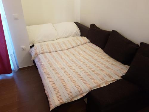 a couch with a blanket on it in a room at Apartments Zova in Medulin
