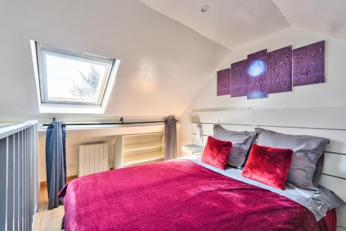 a bedroom with a large bed with red pillows at Promotion du jour - Le Cerisier - in Deuil-la-Barre