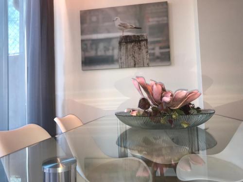a glass table with a bowl of flowers on it at Povoa do Mar in Póvoa de Varzim