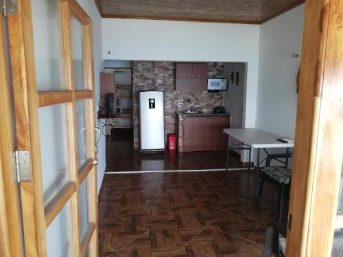 a kitchen with a refrigerator and a table at Casa Madrigueña in Rincón