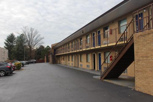 a building with a staircase next to a parking lot at Americas Best Value Inn - Fredericksburg North in Fredericksburg