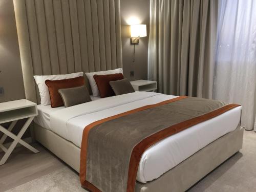 a bedroom with a large bed in a room at HOTEL LES 3 VALLÉES in Saran