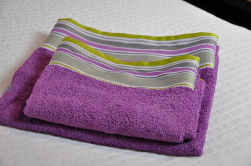 a purple towel sitting on top of a bed at Casa rural La sastreria de Adanero in Adanero