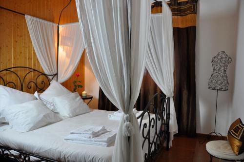 a bedroom with a white bed with a canopy at Casa rural La sastreria de Adanero in Adanero