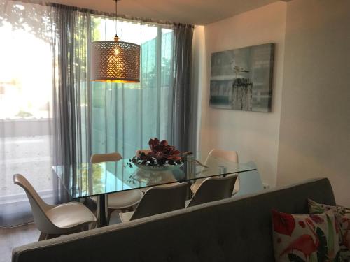 a dining room with a glass table and chairs at Povoa do Mar in Póvoa de Varzim