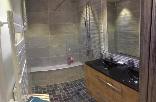 a bathroom with a shower and a black sink at Ti Laouen Karaez in Carhaix-Plouguer