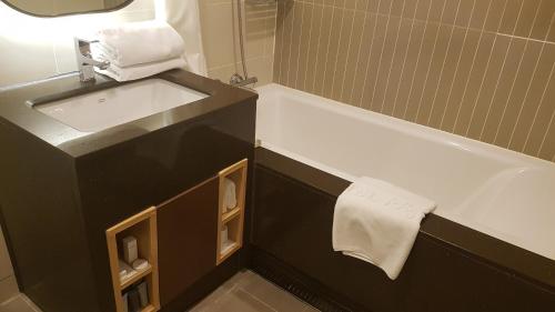 a bathroom with a sink and a bath tub at Hotel Migliore Seoul in Seoul