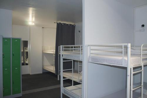 a room with two bunk beds and a locker at Le Coffice Auberge de Jeunesse in Paris