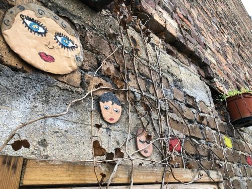 a brick wall with faces painted on it at Le Coffice Auberge de Jeunesse in Paris