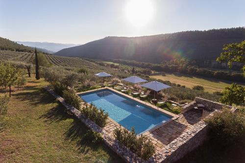 an overhead view of a swimming pool with a rainbow in the background at Borgo di Pianciano in Spoleto