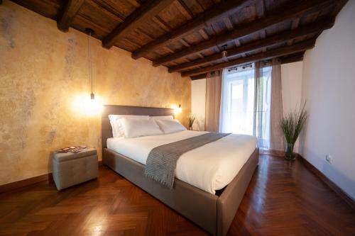 a bedroom with a bed and a large window at Navona Jacuzzi Rooms in Rome