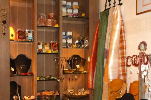 a kitchen with a shelf with various items on it at Hotel Pension Fortuna in Bad Bevensen