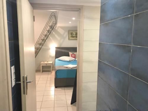 a small room with a bed and a staircase at Odyssey Apartment in Palaiochóra
