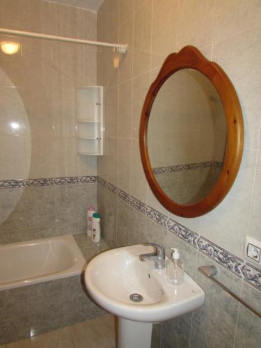 a bathroom with a sink and a mirror and a tub at MOJACAR HOME AND BEACH in Mojácar