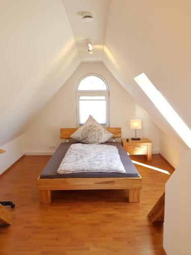 a bedroom with a large bed in a attic at Wunderschöne Wohnungen im Zentrum von Herzogenaurach in Herzogenaurach
