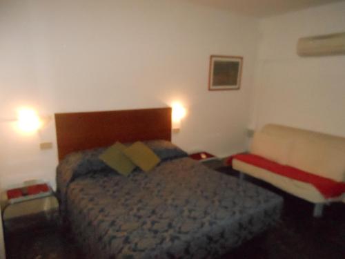 a bedroom with a bed and a chair in it at Cà Del Dose in Venice
