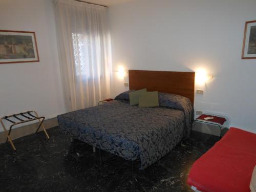 a small bedroom with a bed and a window at Cà Del Dose in Venice