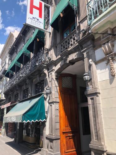 a building with a sign on the side of it at Hotel Elena in Puebla