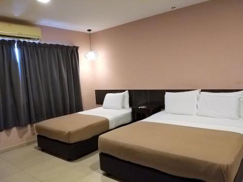 Ένα ή περισσότερα κρεβάτια σε δωμάτιο στο Hotel Jelai @ Mentakab