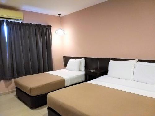 Ένα ή περισσότερα κρεβάτια σε δωμάτιο στο Hotel Jelai @ Mentakab
