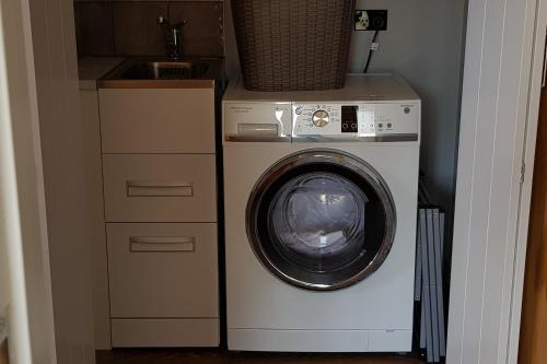 a washing machine and a sink in a room at The Rest in Twizel