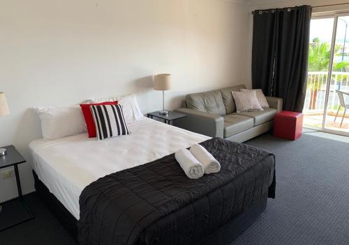 a hotel room with a bed and a couch at Outrigger Burleigh in Gold Coast