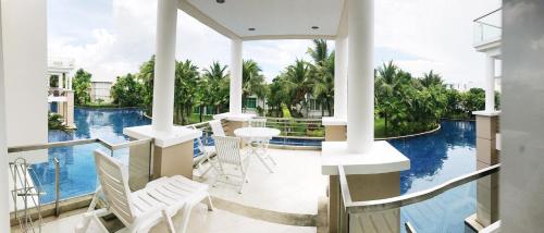 a view from the balcony of a house with a swimming pool at Hua Hin Blue Lagoon in Cha Am