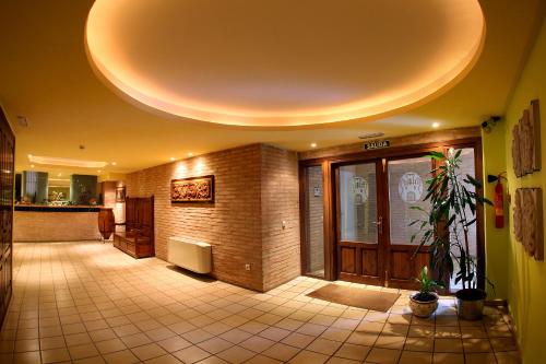 a building with a lobby with a large door at Hotel Villa de Alquézar in Alquézar