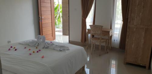a bedroom with a bed with flowers on it at Sun Homestay Canggu in Canggu
