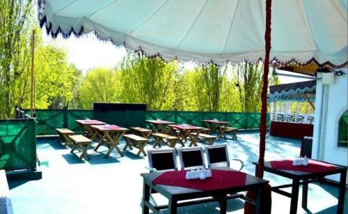 a group of tables and chairs under a tent at Hotel Green Leaf Srinagar in Srinagar