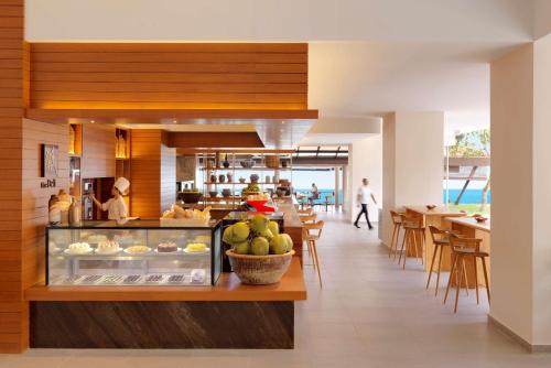 a restaurant with a counter with food on it at Hyatt Regency Kuantan Resort in Kuantan