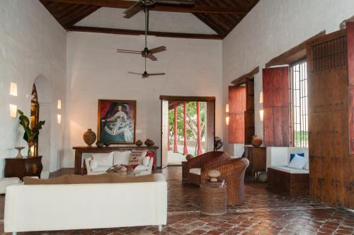 a living room with a couch and a ceiling fan at Portal de la Marquesa in Mompos