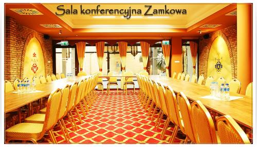 a conference room with a long table and chairs at Hotel Fajkier in Kroczyce