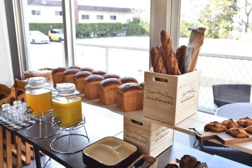 a table with a bunch of bread and pastries on it at Alaise De Bale Shirahama in Shirahama