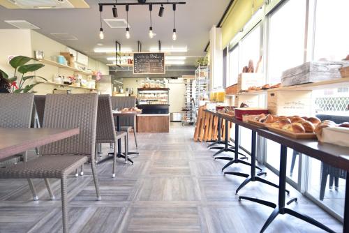 a restaurant with tables and chairs and a bakery at Alaise De Bale Shirahama in Shirahama