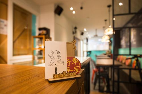 a sign sitting on top of a wooden table at mydeer backpacker in Tainan