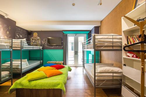 a room with two bunk beds and a tv at mydeer backpacker in Tainan