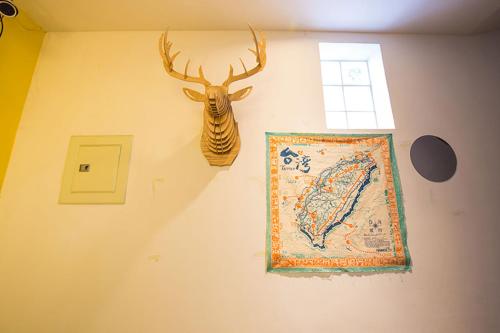 a wall with a picture of a deer head on it at mydeer backpacker in Tainan