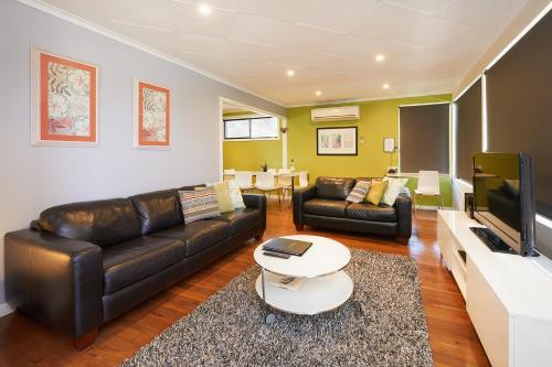 a living room filled with furniture and a couch at Albany Harbourside Apartments And Houses in Albany