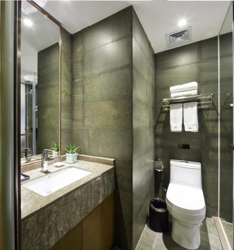 a bathroom with a toilet and a sink at INSAIL Hotel (Shenzhen Dongmen Branch) in Shenzhen