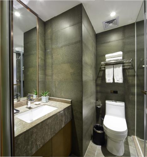 a bathroom with a toilet and a sink at INSAIL Hotel (Shenzhen Dongmen Branch) in Shenzhen