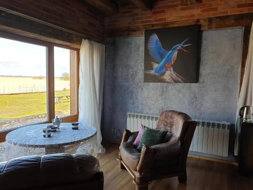 a living room with a bird painting on the wall at DOM GOŚCINNY PTASZARNIA - NATURA-Free PARKING in Świnoujście